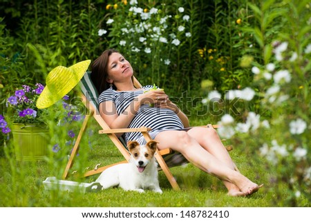 Pregnant woman relaxing in the garden