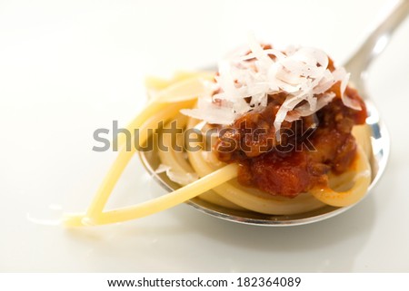 Spaghetti with tomato beef sauce on a spoon