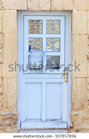 Traditional old vintage blue painted wooden door in Provence, France, Europe.