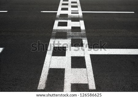 Start and Finish motor race line asphalt on Monaco Montecarlo Grand Prix street circuit