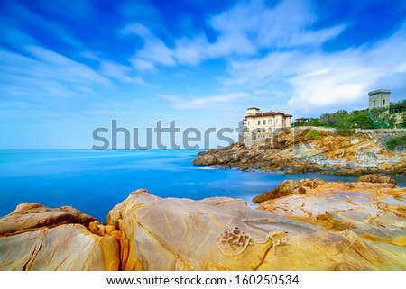 Boccale castle landmark on cliff rock and sea in winter. Long exposure photography. Tuscany, Italy, Europe