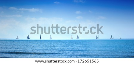 Sailing boat yacht or sailboat group regatta race on sea or ocean water. Panoramic view.