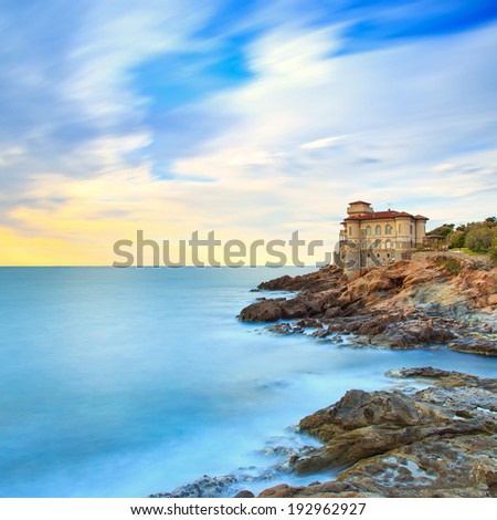 Boccale castle landmark on cliff rock and sea on sunset. Tuscany, Italy, Europe. Long exposure photography.