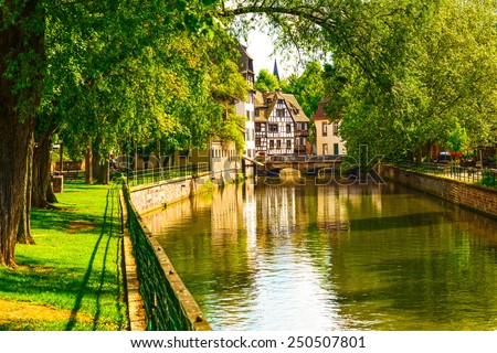 Strasbourg, water canal in Petite France area. Half timbered houses and trees in Grand Ile. Alsace, France. Unesco Site.