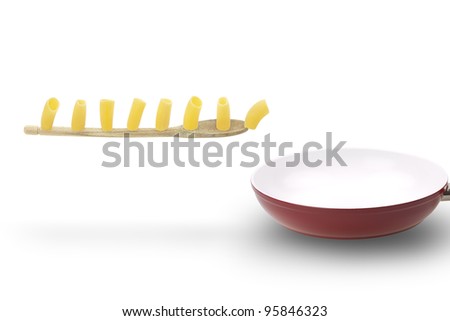 Italian typical pasta march on flying wooden spoon into a ceramic pan