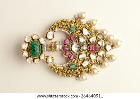Close up of diamond earring with many stones, pearls and diamonds on white background