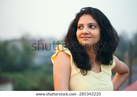 A beautiful Indian smiling girl feeling relaxed in the fresh air of the morning