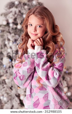 Smiling Teenager Girl 12 15 Year Old Wearing Trendy Sweater Over Christmas Tree Looking Smiling Teenager Girl 12 15 Year Old Wearing Trendy Sweater Over Christmas Tree Looking