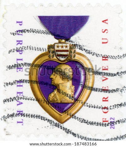 UNITED STATES OF AMERICA - CIRCA 2012: first class forever post stamp printed in US shows purple heart medal on ribbon; honors veterans sacrifices served in US military; purple gold; circa 2012
