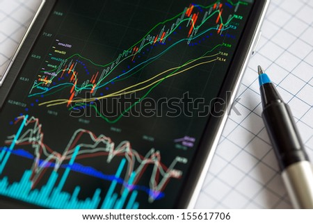 Data analyzing in stock exchange market: the charts and quotes on smartphone display.
