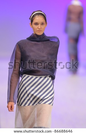 KYIV, UKRAINE - OCT. 14, 2011: Model walks the runway during Fashion Show by \