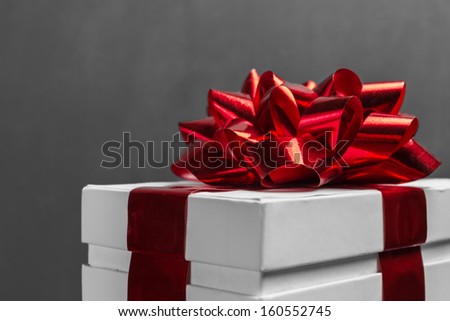 White gift box with red ribbon, close-up