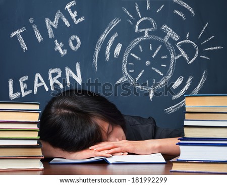 Tired woman sleeps between the stacks of books, on blackboard text time to learn, concept of education