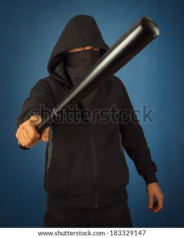 Dangerous man with baseball bat ready for fight