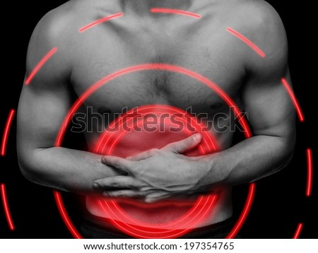 Young man compresses the abdomen due to pain, black and white image, pain area of red color