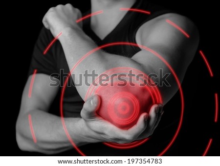 Man holds his the elbow joint, acute pain in the elbow, black and white image, pain area of red color