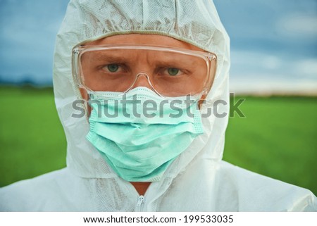 Portrait of serious scientist man in protective uniform outdoor