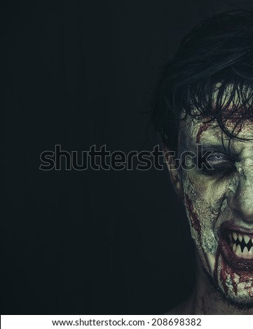Half portrait of hungry zombie man with copy-space at left image, Halloween makeup