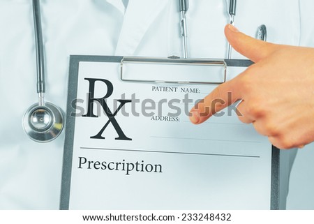 Unrecognizable man doctor pointing on clipboard with prescription list