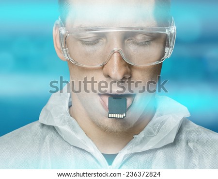 Young man or robot holding digital memory card on his tongue, memory and futuristic concept