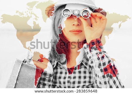 Double exposure map of the world combined with image of traveler young woman looking through binoculars outdoor