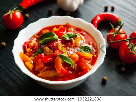 Delicious letcho with fresh vegetables in bowl on dark wooden background Stock fotó © 