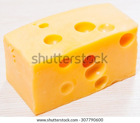piece of fresh delicious cheese with holes