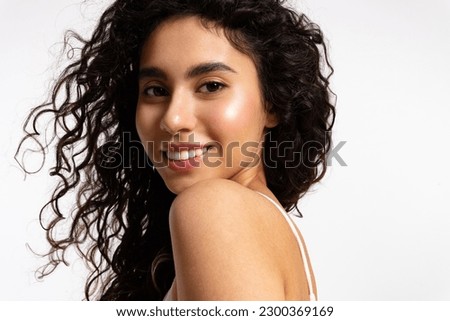 Similar – Image, Stock Photo Gorgeous dark-haired young woman stands with big eyes and demanding look in an old willow tree with fine shoulders