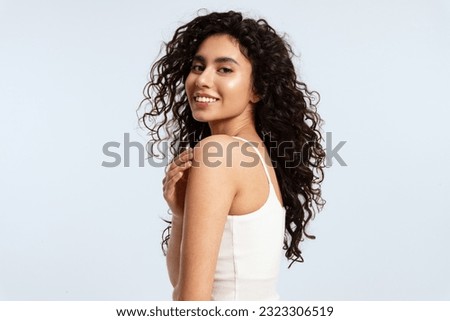 Similar – Image, Stock Photo Gorgeous dark-haired young woman stands with big eyes and demanding look in an old willow tree with fine shoulders