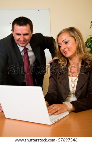 Business man and woman working on laptop in the office