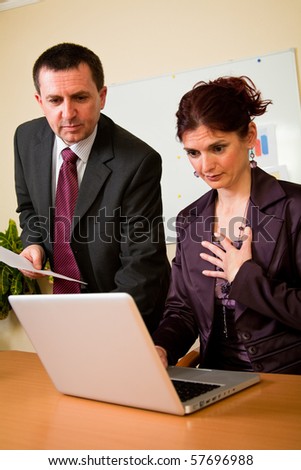 Business man and woman working in laptop in the office