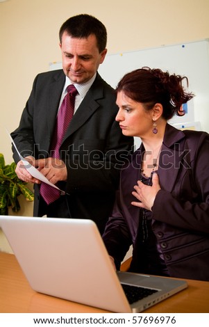 Business man and woman working in laptop in the office