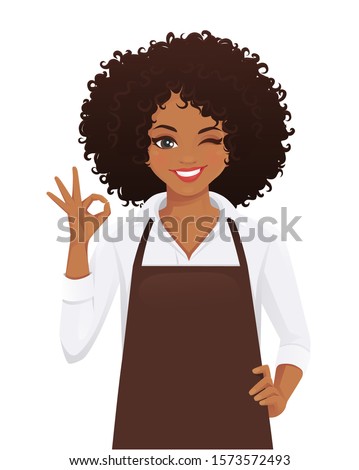 Smiling woman in apron with afro hairstyle gesturing ok sign isolated vector illustration