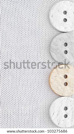 four buttons made of coconut on a light silk-cotton fabric