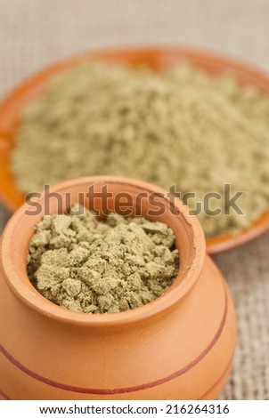 ceramic dishes filled with raw organic hemp protein powder