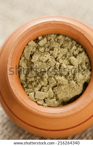 ceramic dish filled with raw organic hemp protein powder
