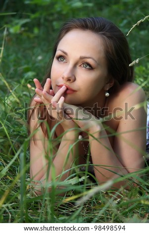 girl dreams in  grass. Summer,  sunny day.