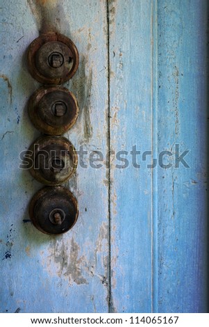 Old  lighting switch on abstract blue old wooden background