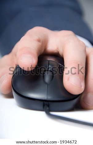 man\'s hand on a computer mouse