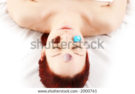 woman getting cold stone therapy on chakras