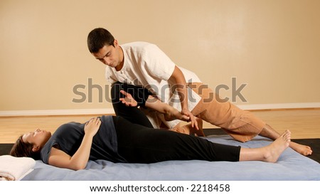 man therapist stretching woman client in massage