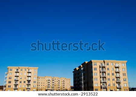 modern beige and brown apartment condos on blue sky