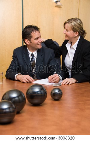 man and woman in a room with a paper pad writing