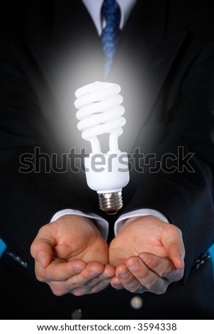 two hands with a floating light bulb