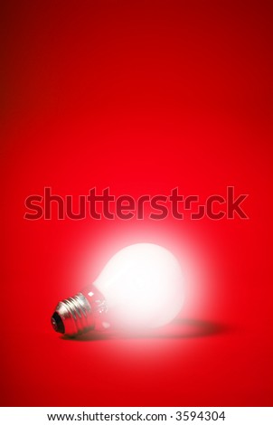 incandescent light bulb on a red background