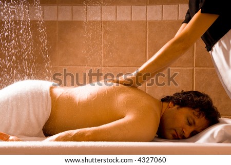 happy relaxing man getting a hydro massage