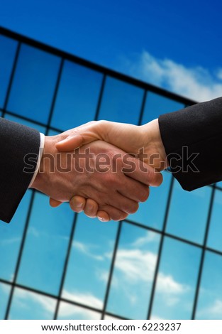 a business hand shake outside the office building