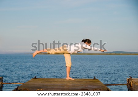 Yoga Woman on a dock by the ocean