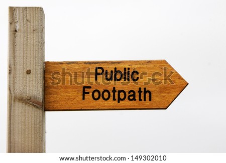 A sign indicating the direction of the public footpath