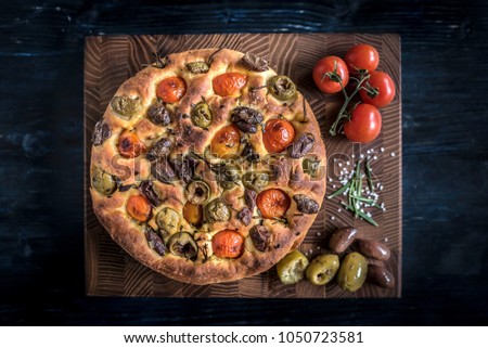 Similar – Image, Stock Photo Homemade Italian Focaccia, with tomato and olive oil on a rustic wooden background.